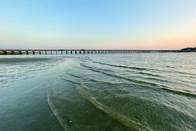 Scenic view of sea against clear sky during sunset