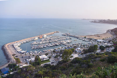 High angle view of sea and buildings against sky