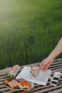Cropped image of hand holding food on table