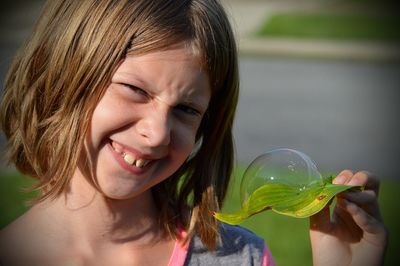 Close-up of girl holding leaf