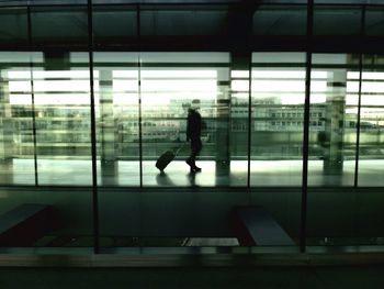 Reflection of people in glass building