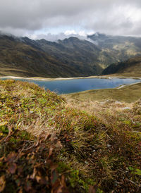 Scenic view of land and mountains against sky