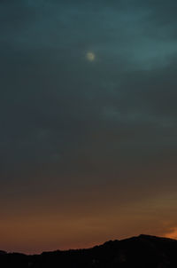 Scenic view of silhouette mountains against sky at night