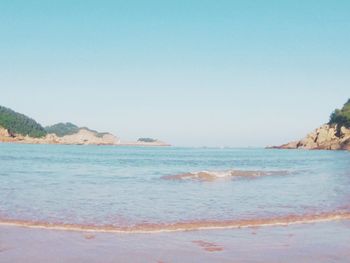 Scenic view of sea against clear blue sky