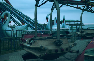 Close-up of amusement park ride against sky