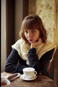 Portrait of woman sitting at home