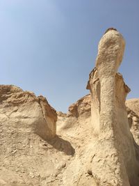 Low angle view of rock formation against sky