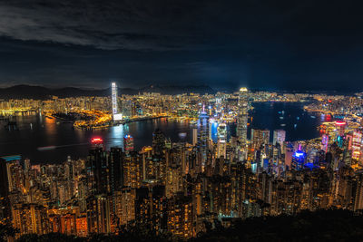 Illuminated cityscape against sky at night