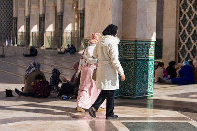 Rear view of people walking in temple