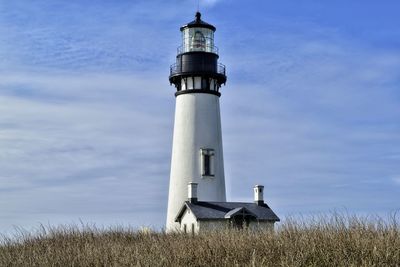 Lighthouse against cloudy sky