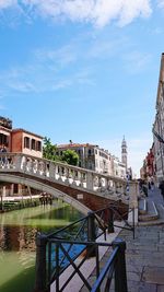 Bridge over canal against buildings in city