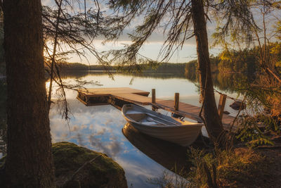 Boats moored on lake against sky
