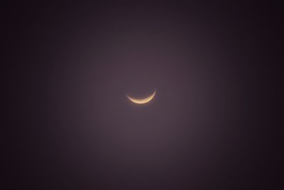 Low angle view of moon against sky at night