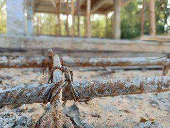 Close-up of rope tied to metal fence