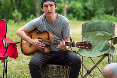Full length of man playing guitar