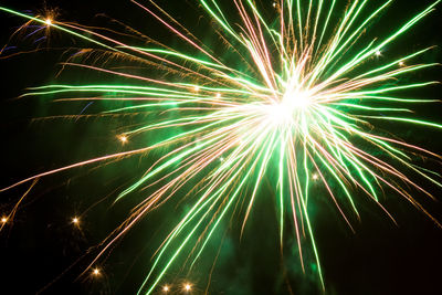 Low angle view of firework display at night