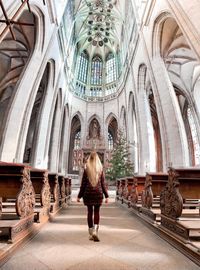 Full length rear view of woman walking in temple