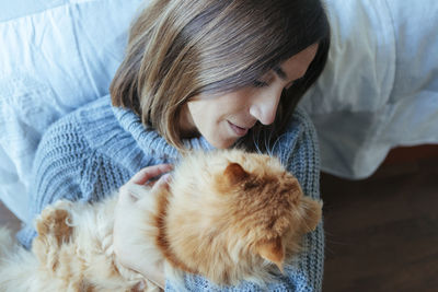 Midsection of woman with cat