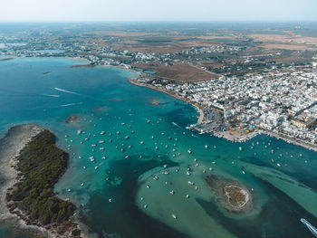 High angle view of sea and buildings against sky