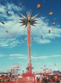 Low angle view of amusement park ride against sky