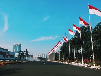 Flags in city against sky
