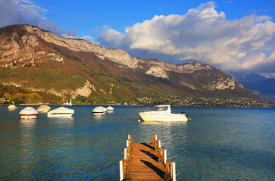 Scenic view of lake and mountains against sky