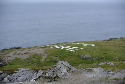 High angle view of rocks on sea shore