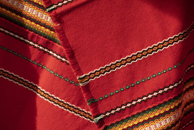 Red tablecloth in russia. folk pattern on the fabric. fabric material in the slavic peoples. 