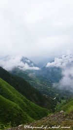 Scenic view of mountains against cloudy sky