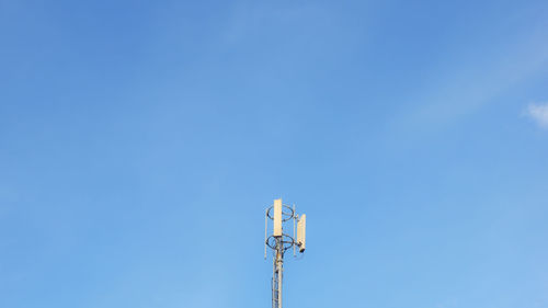 Low angle view of street light against blue sky