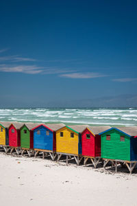 Famous colorful beach houses in muizenberg near cape town, south africa against blue sky