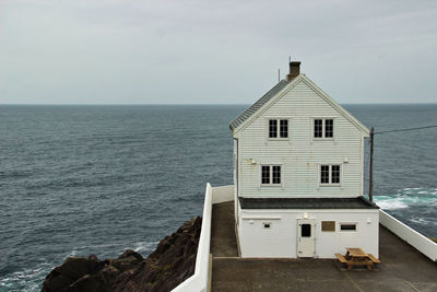 Building by sea against sky, lighthouse 