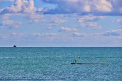 Floating platform in sea against sky