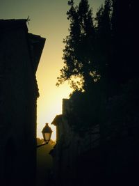 Low angle view of silhouette buildings against sky