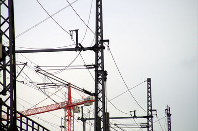 Low angle view of electricity pylon against sky