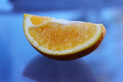 Close-up of lemon wedge on table