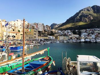 Panoramic shot of buildings by sea against clear sky