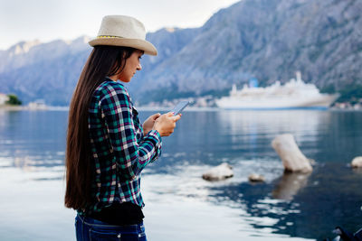 Woman standing by sea