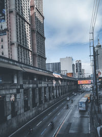 View of city street and buildings against sky