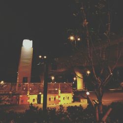 Illuminated cityscape against clear sky at night