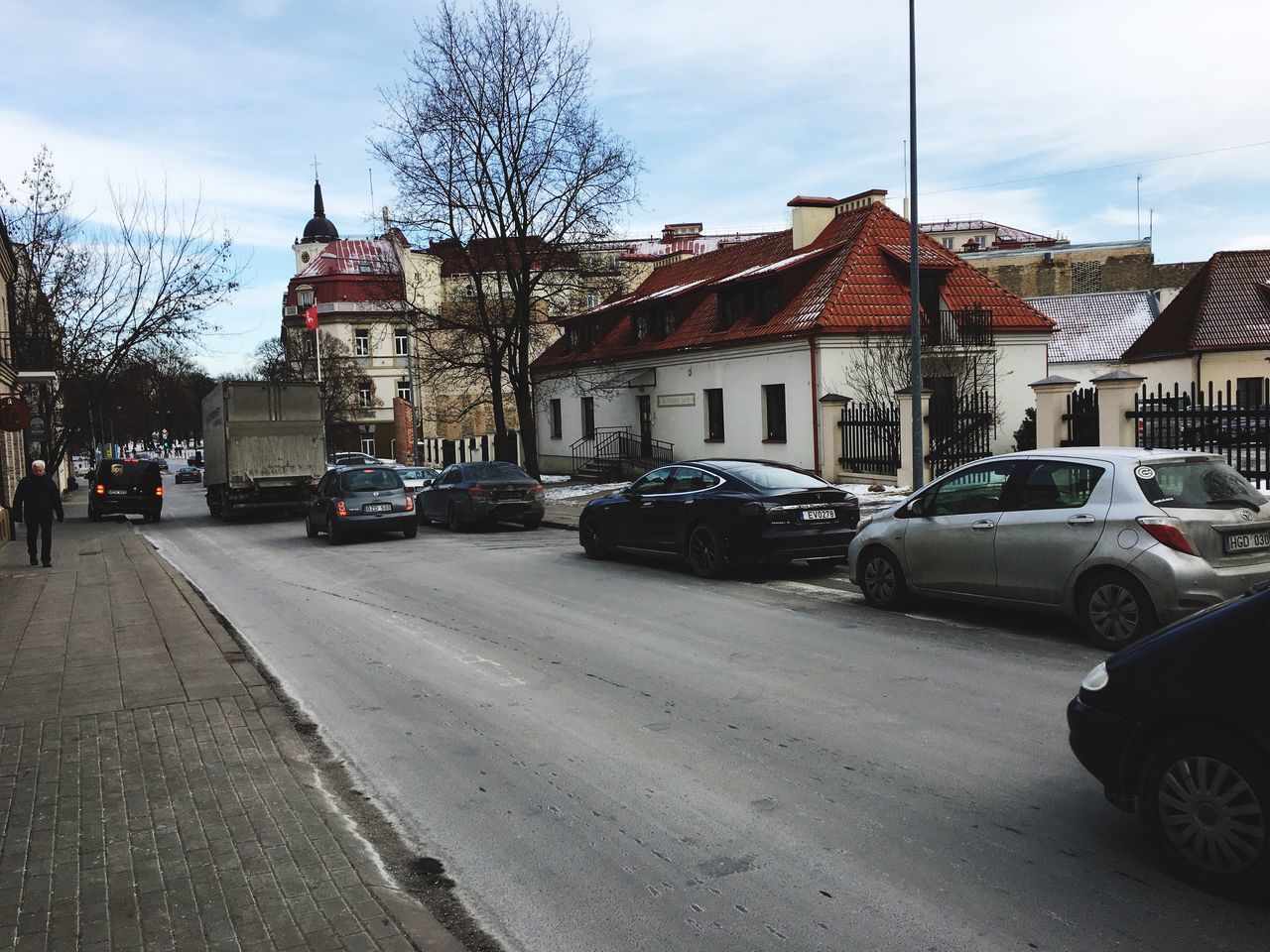 VEHICLES ON ROAD IN CITY AGAINST SKY