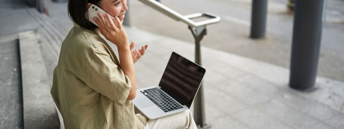 Midsection of man using digital tablet