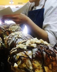 Close-up of hand holding ice cream cone at night