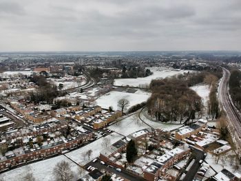 High angle view of cityscape by sea against sky