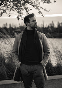 Man in front of water and vegetation monochrome 