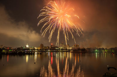 Firework display over city at night