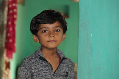 Portrait of cute boy against wall