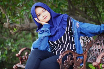 Portrait of mid adult woman sitting on land