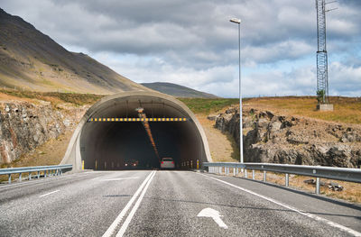 Road by bridge against sky