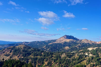 Scenic view of mountains against blue sky